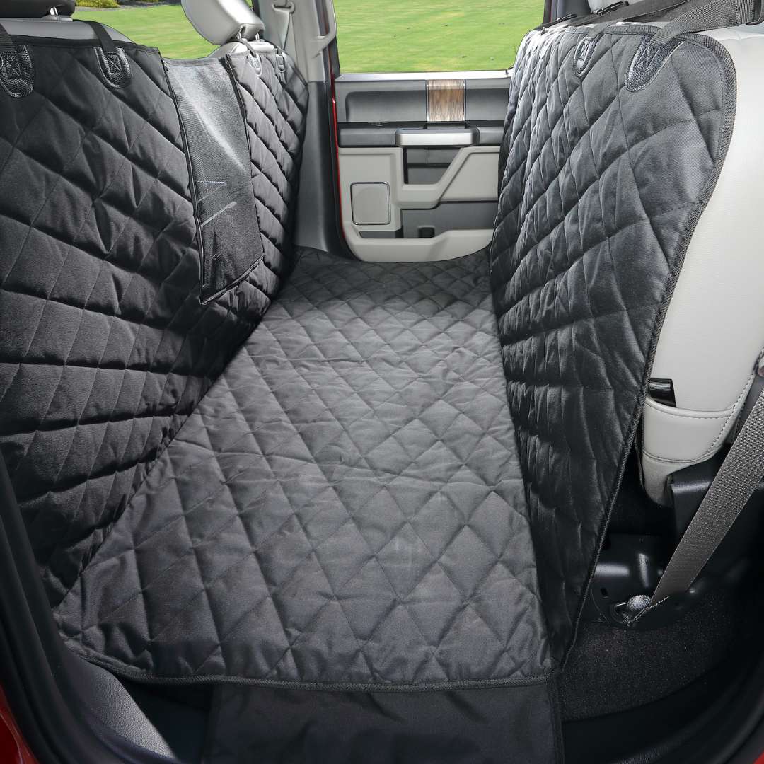 Black Floor Hammock covering the floor between the front seats and the folded-up rear seats of a crew cab
