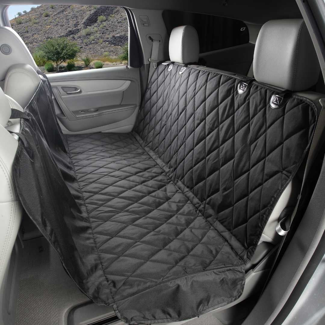 Black quilted 4Knines seat cover set up as a hammock across the back seat of an SUV