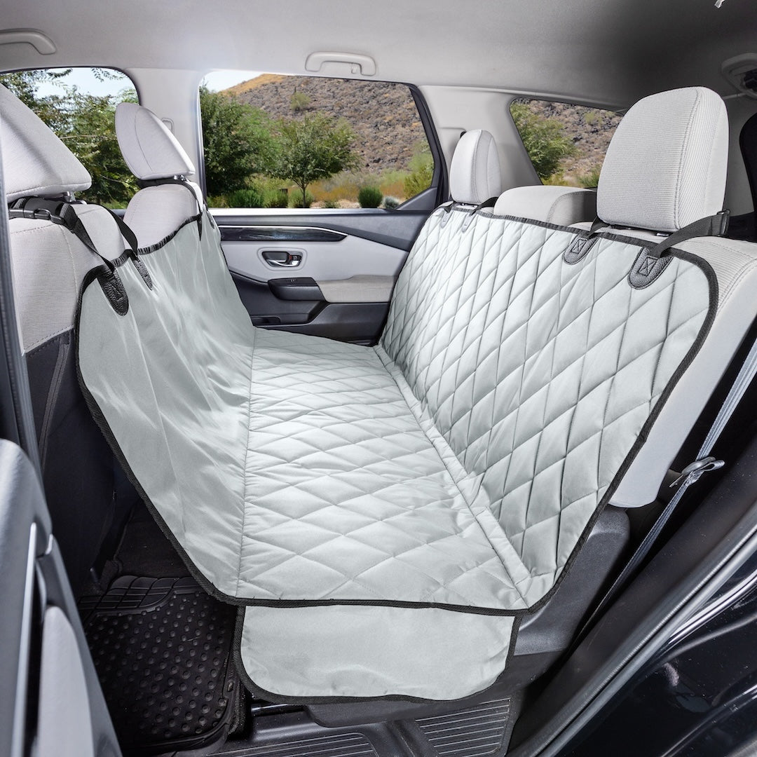 Grey quilted 4Knines seat cover in hammock mode in an SUV's back seat
