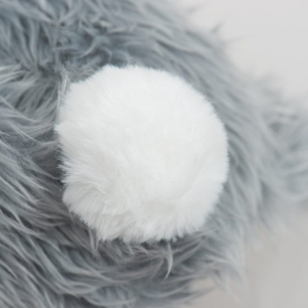 Close-up of the bunny toy's white pom-pom tail