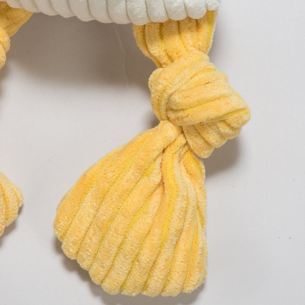Close-up of the duck toy's yellow corduroy foot tied in a knot
