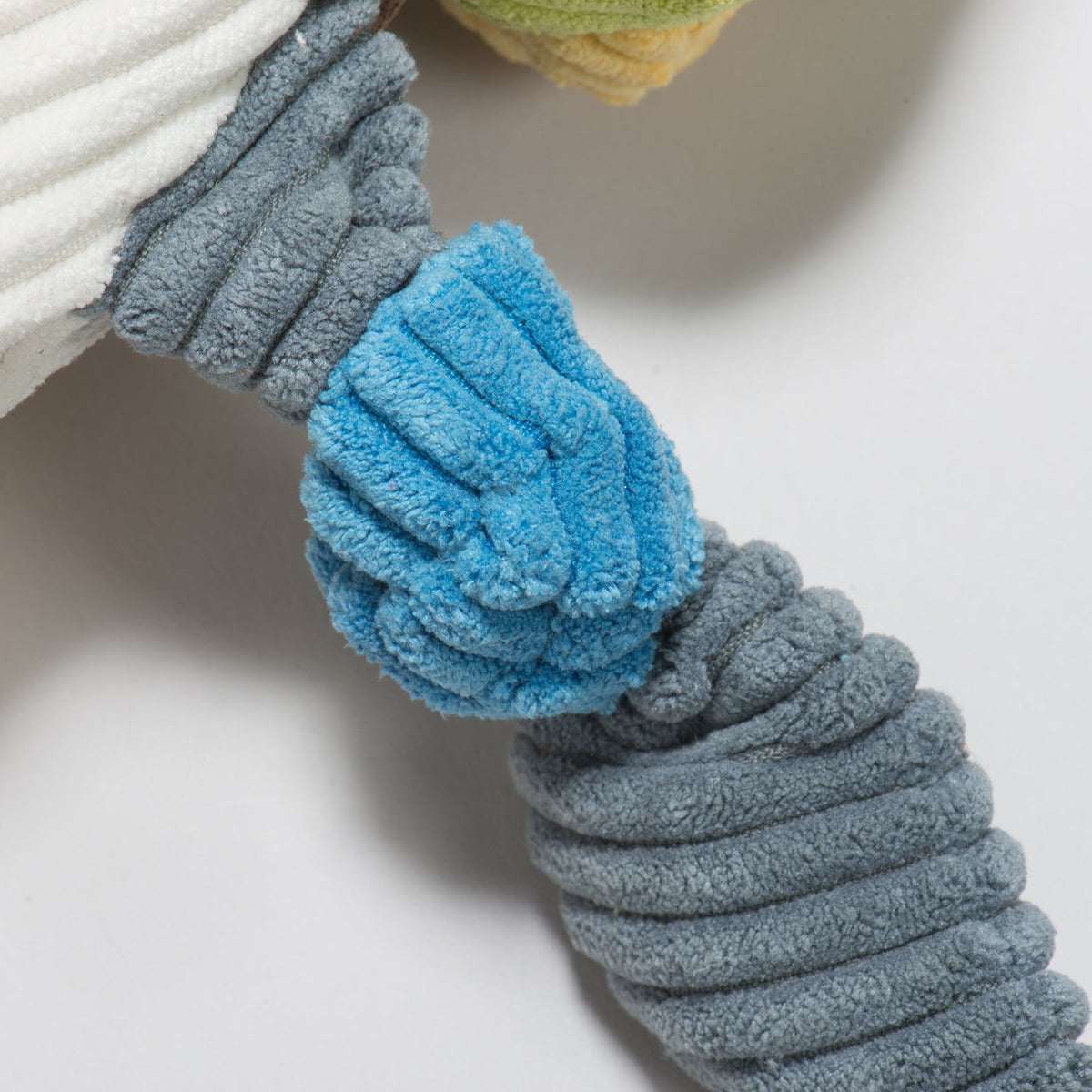 Close-up of a knotted wing in blue and gray corduroy
