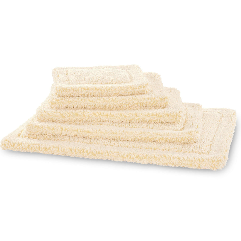 Stack of cream fleece pet mats in several sizes