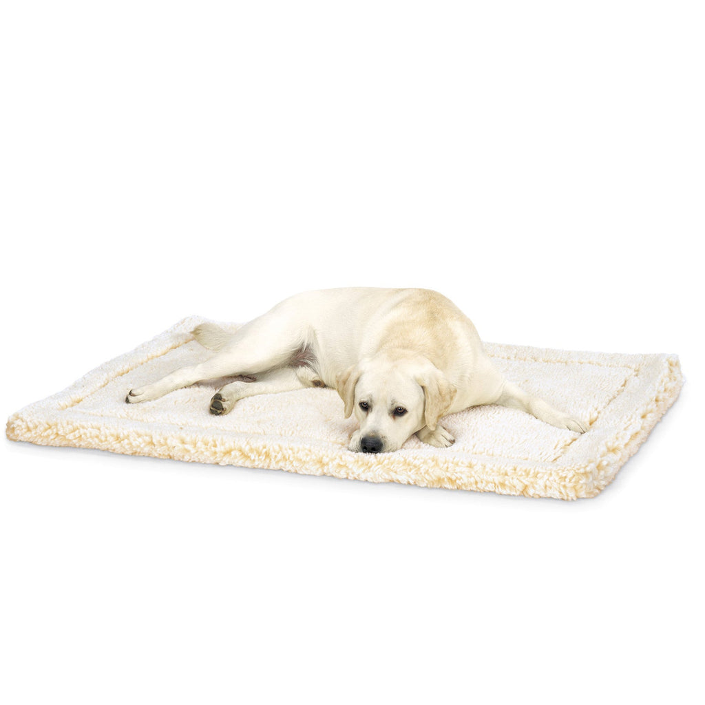 Yellow Labrador lying on a cream fleece pet mat