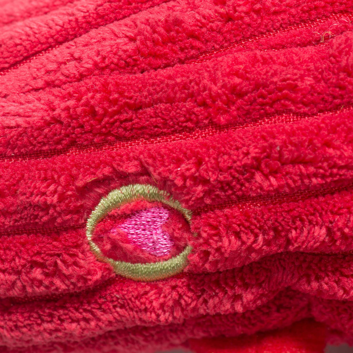 Close-up of the embroidered heart patch on the red lobster toy