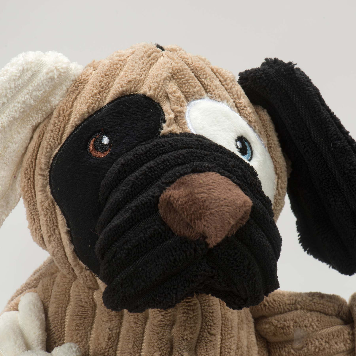 Close-up of the Patches toy's face: black patch over one eye, brown nose and a black muzzle