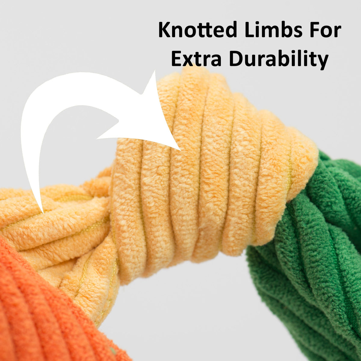 Close-up of a knotted corduroy toy limb in orange, yellow and green