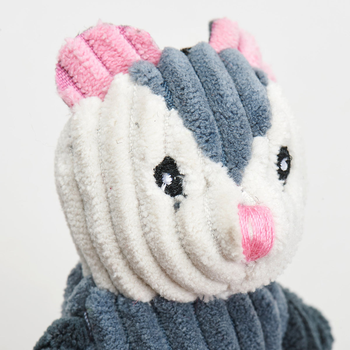 Close-up of the opossum toy's pink embroidered nose