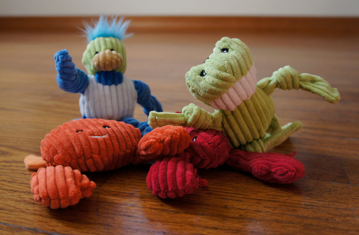 Water Critters cat toys on a wooden floor: a duck, a frog, an orange crab and a red lobster