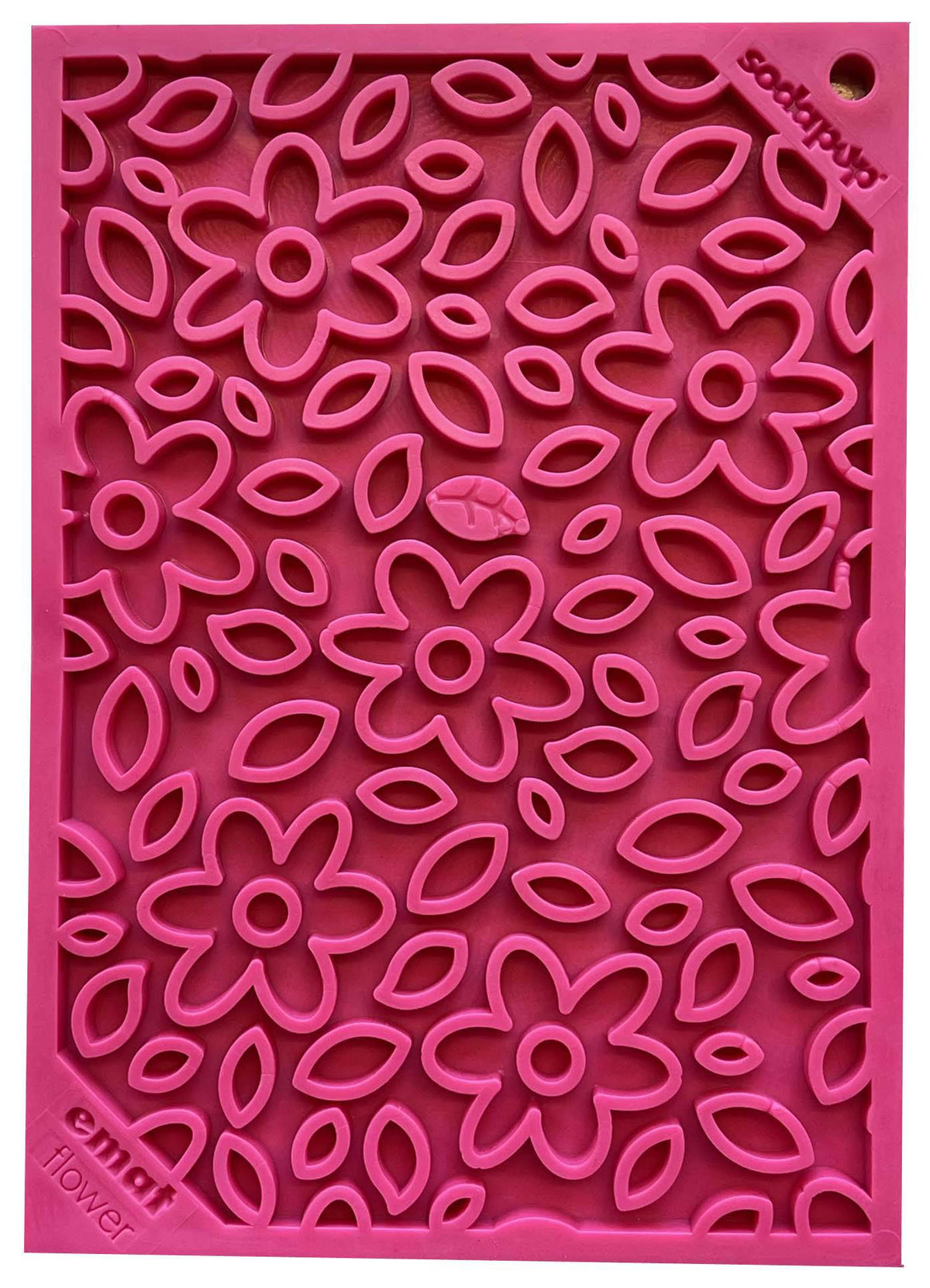 Pink rubber lick mat with a raised flower pattern, seen from above
