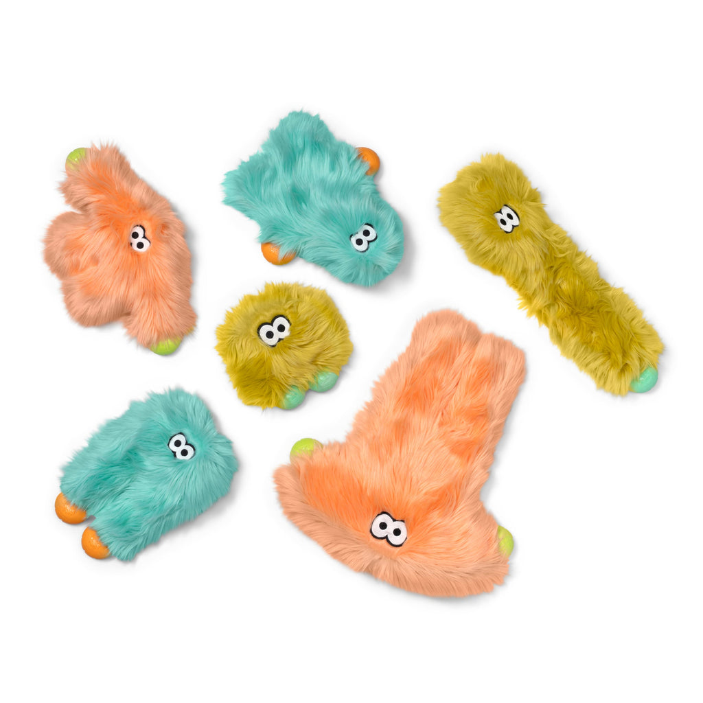 Group of shaggy plush dog toys in mint, peach and olive in several shapes