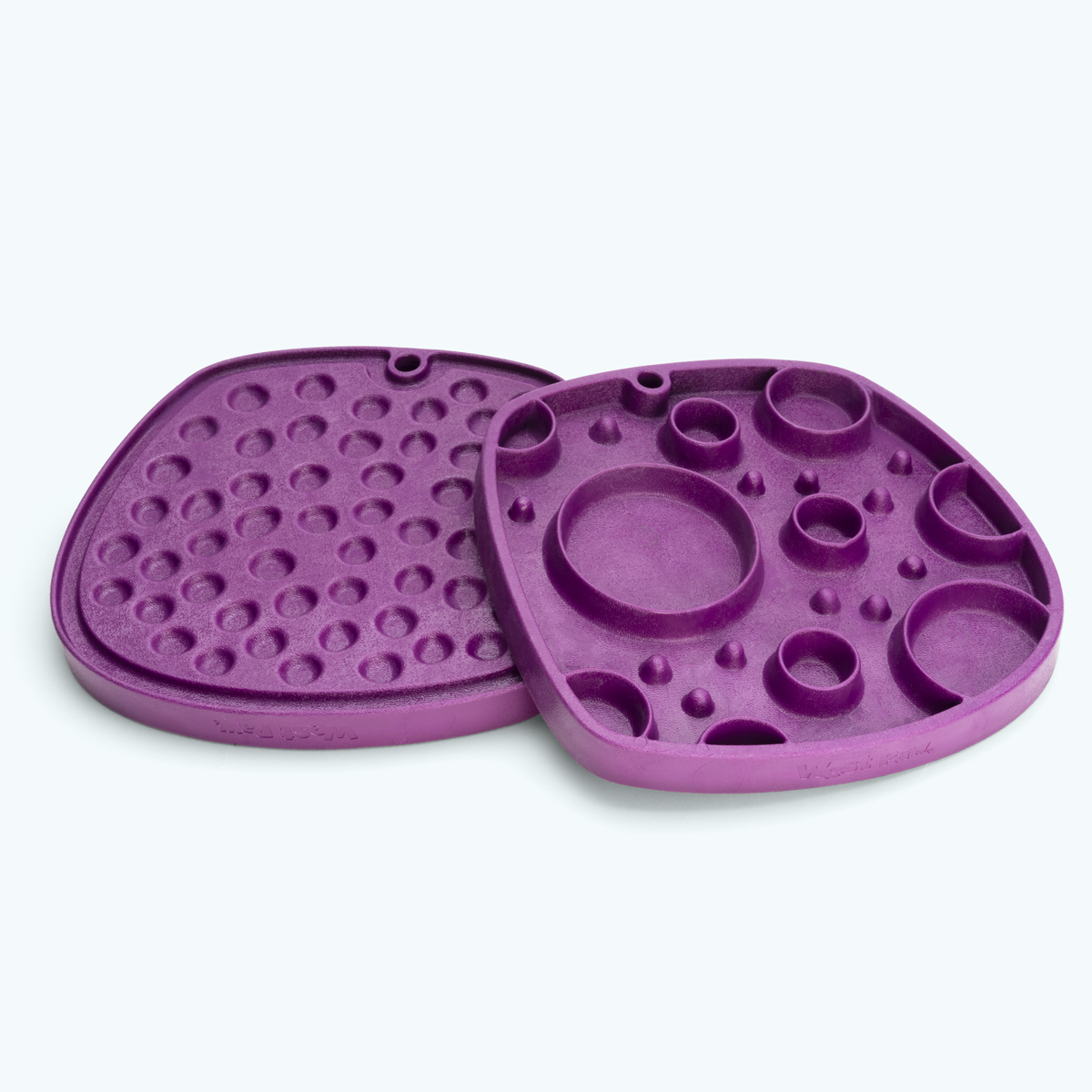 Two purple feeding mats with round wells and raised dots