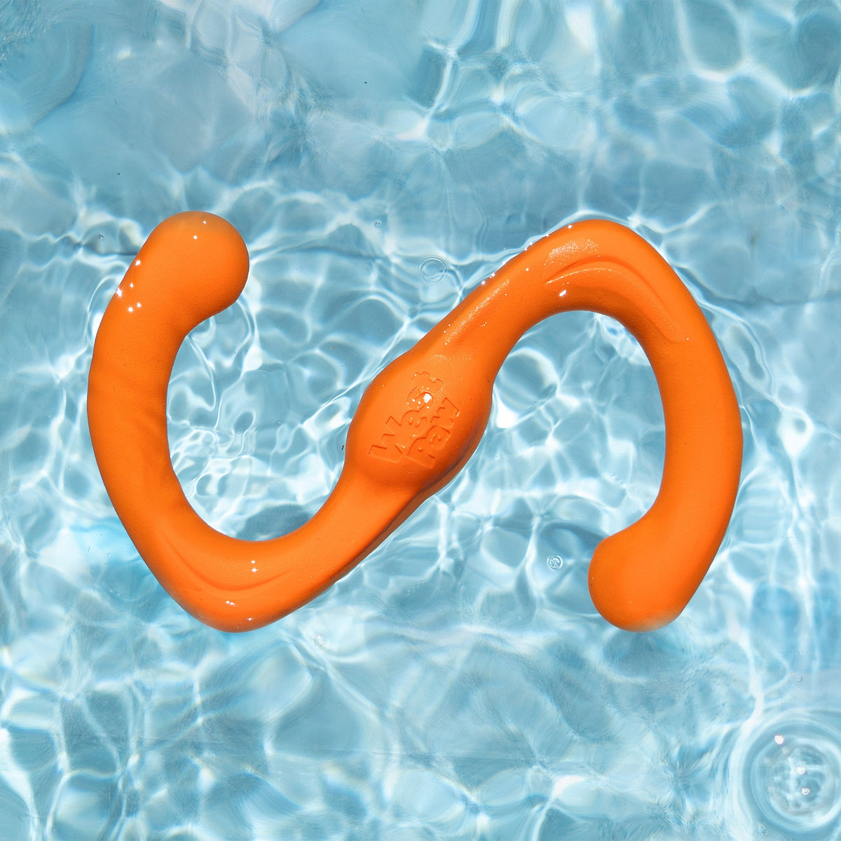 Orange S-shaped tug toy floating in a pool
