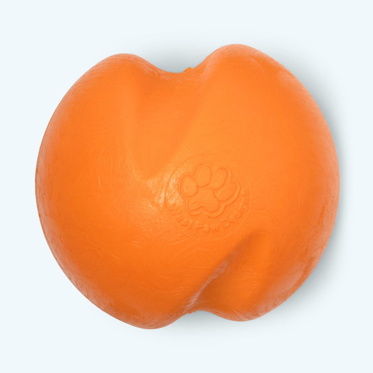 Orange bouncy rubber ball dog toy, close-up