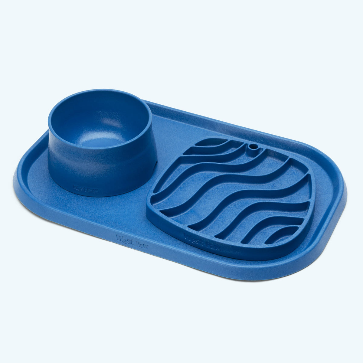 Blue bowl and wavy lick mat on a matching blue placemat