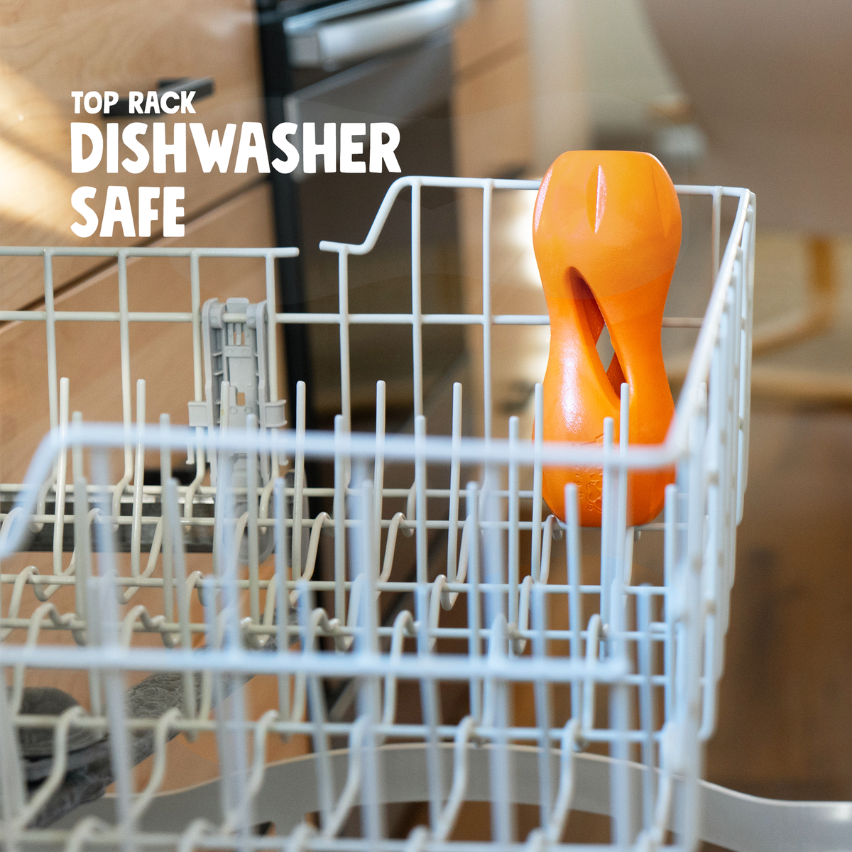 Orange treat toy in the top rack of a dishwasher