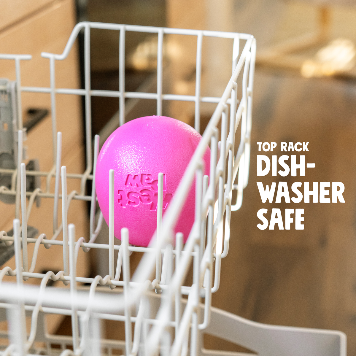 Pink treat toy in the top rack of a dishwasher