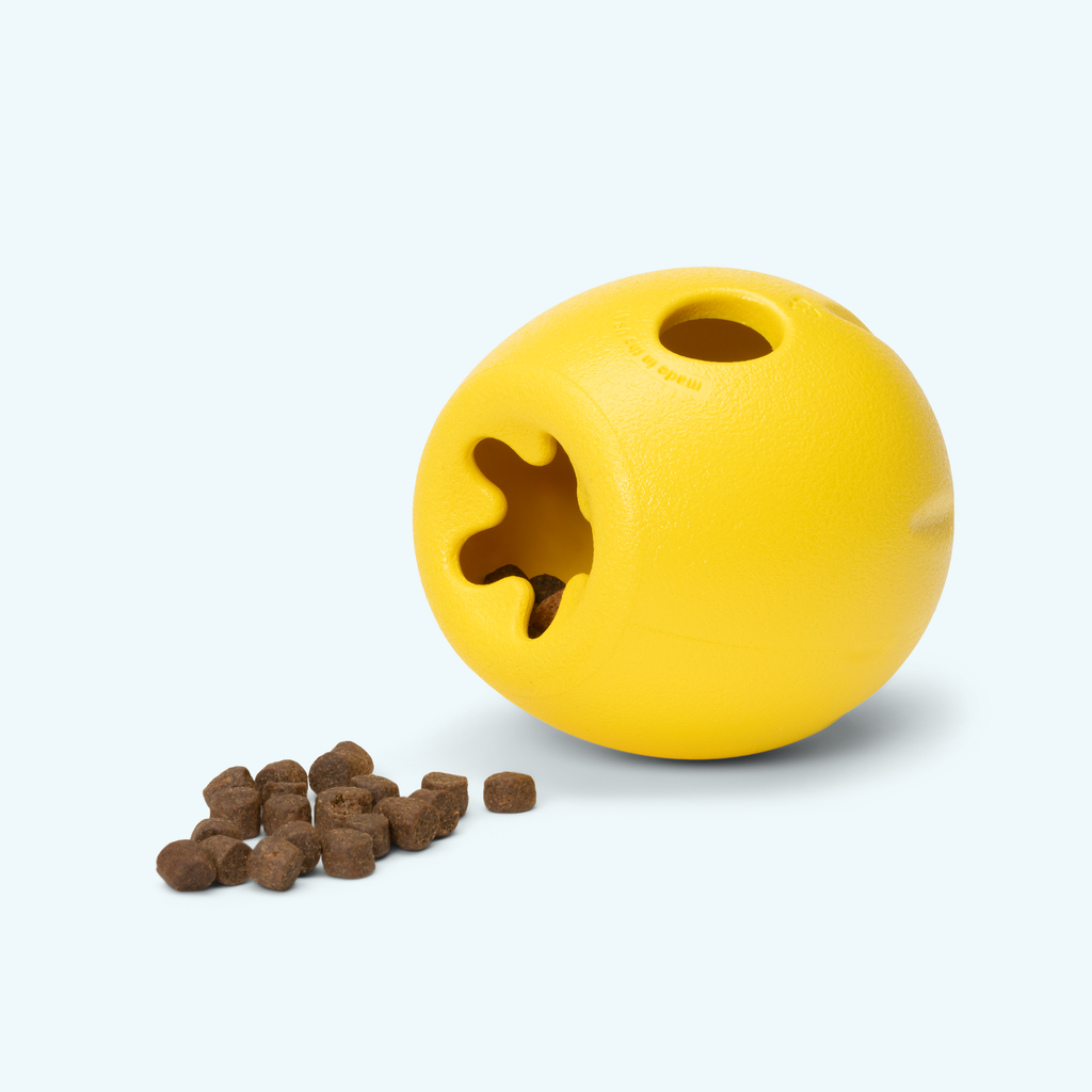 Yellow egg-shaped treat toy with kibble spilling out