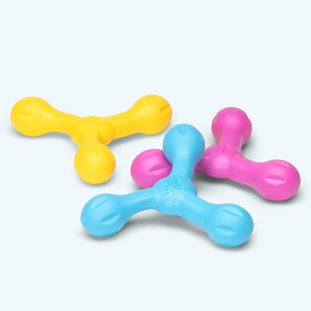 Three-armed rubber fetch toys in yellow, blue and pink