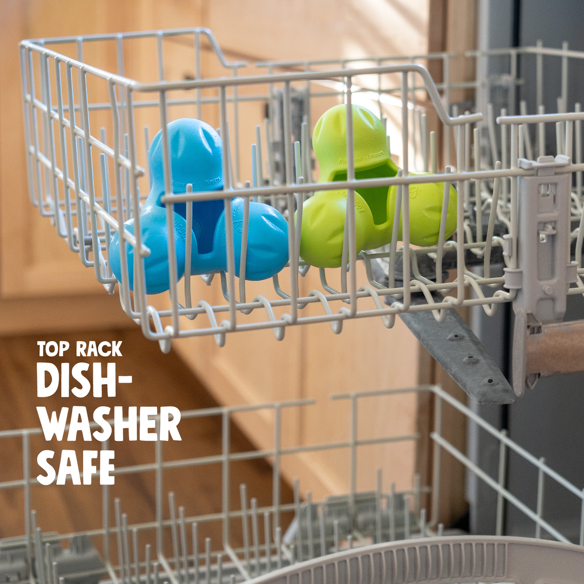 Blue and lime treat toys in the top rack of a dishwasher