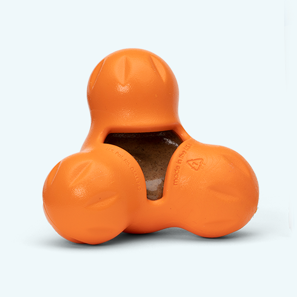 Orange three-lobed rubber treat toy with a treat inside
