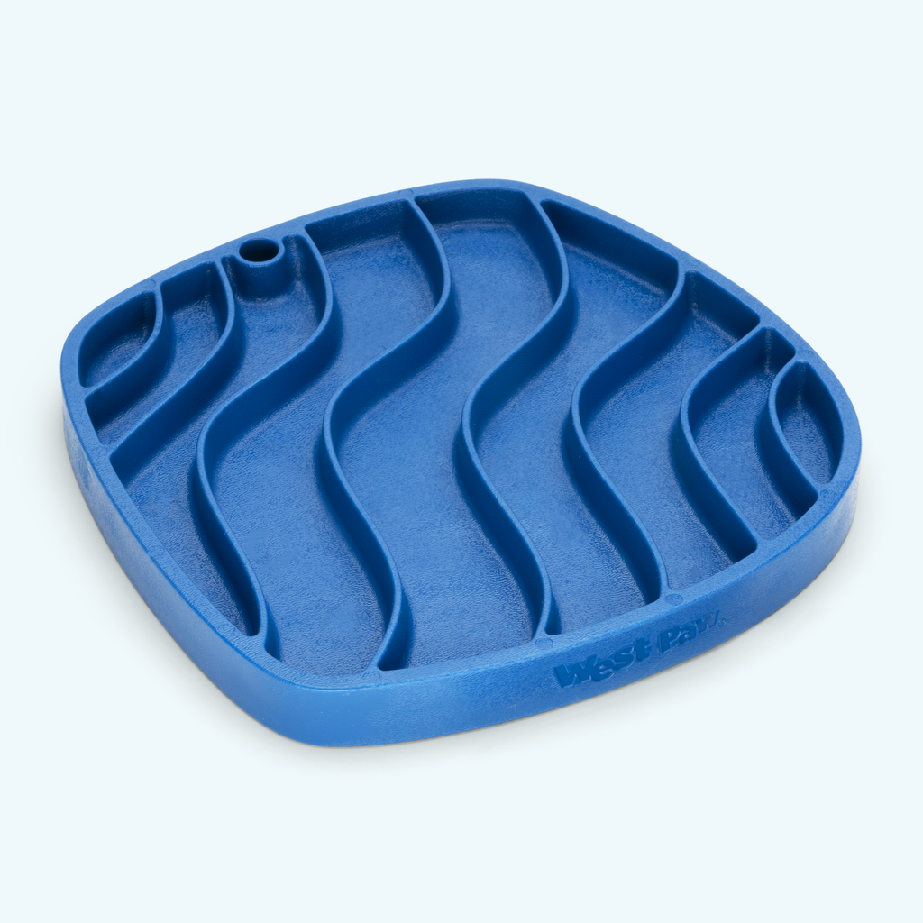 Blue rubber lick mat with a wavy groove pattern