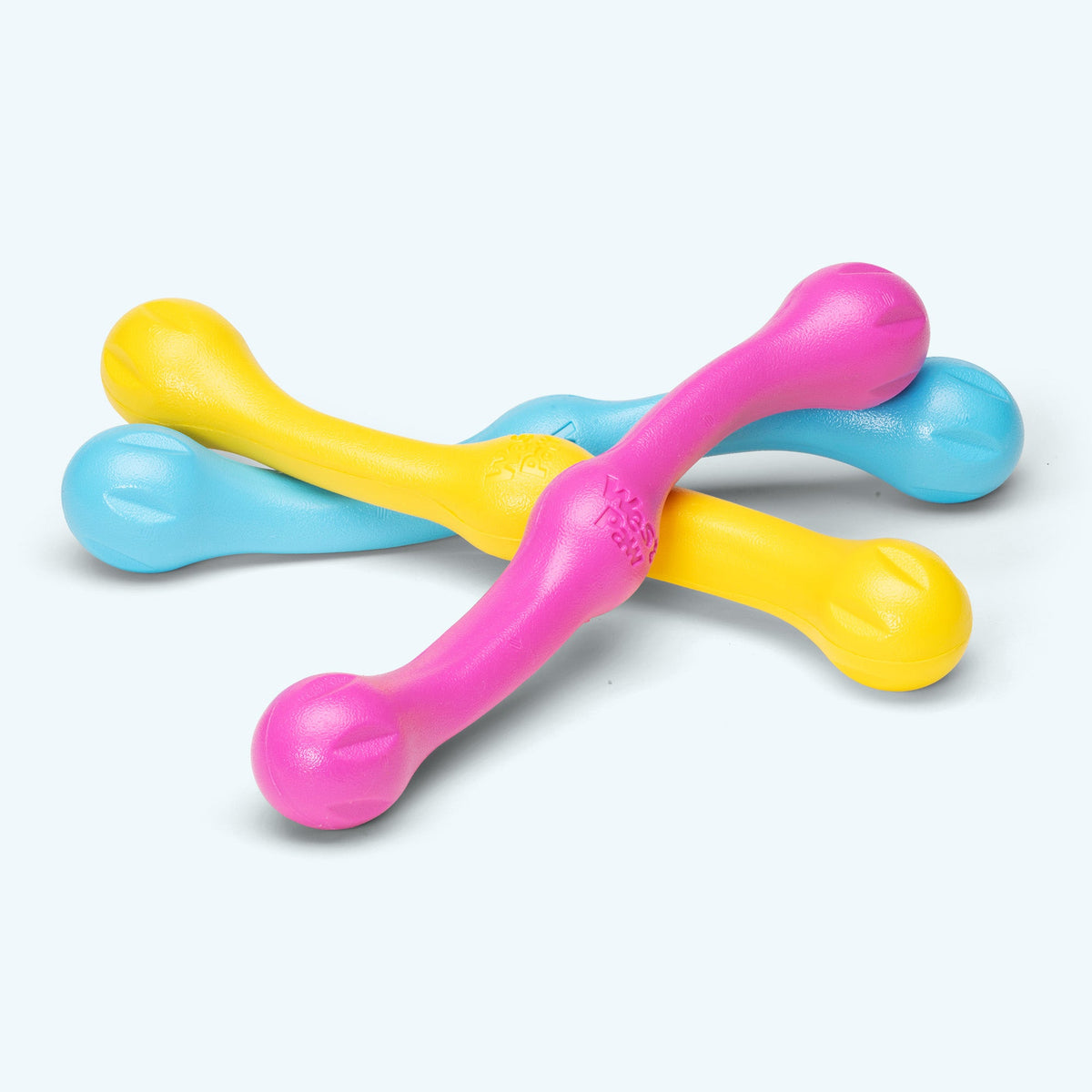 Stick-shaped rubber fetch toys in yellow, blue and pink